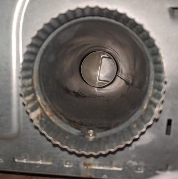 Dryer vent after cleaning — clear metal duct with full airflow